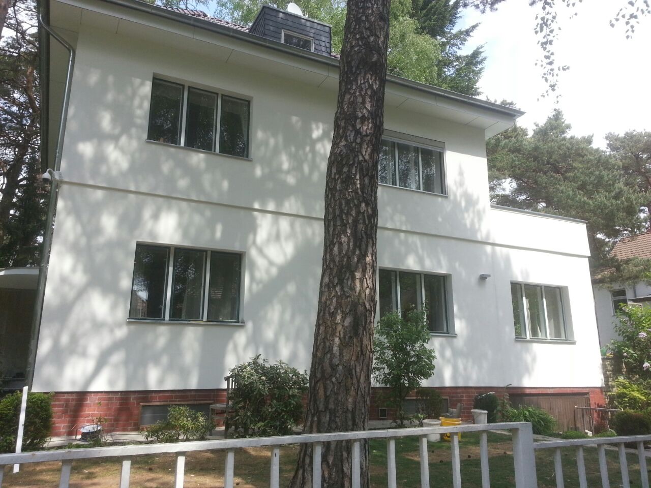 Zweigeschossiges Wohnhaus mit frisch verputzter weißer Fassade